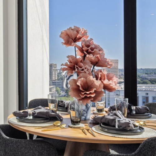 All the comforts of luxury living dining room with large windows